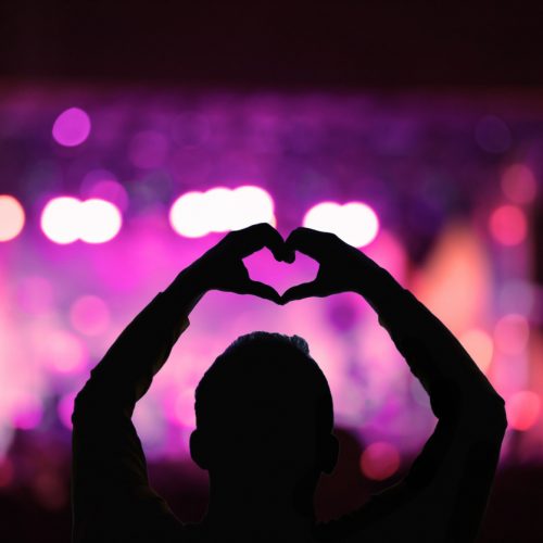 Silhouette of a man with concert stage lights